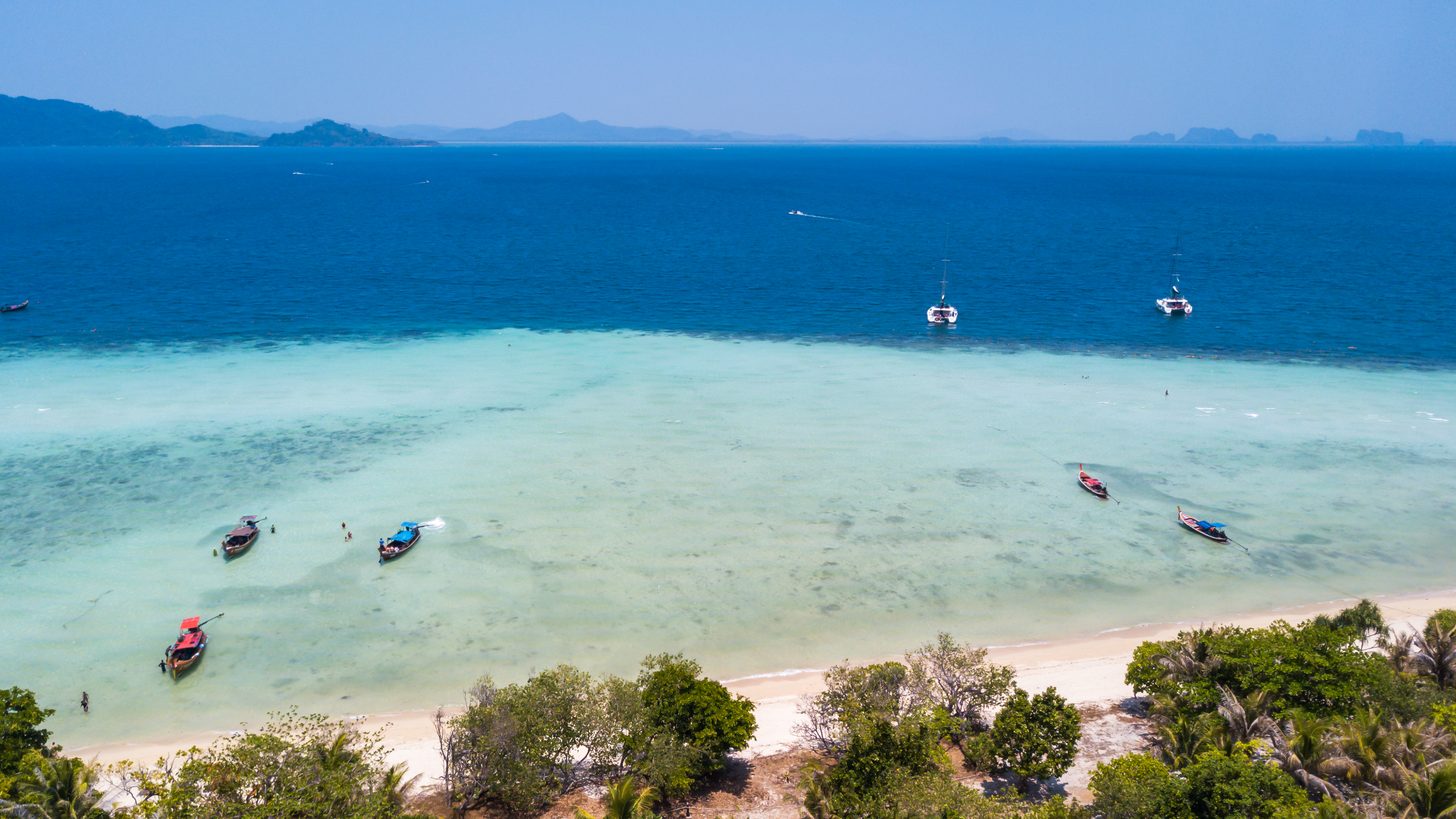 Aerial view of the long white-sand beach on Koh Kradan, Trang