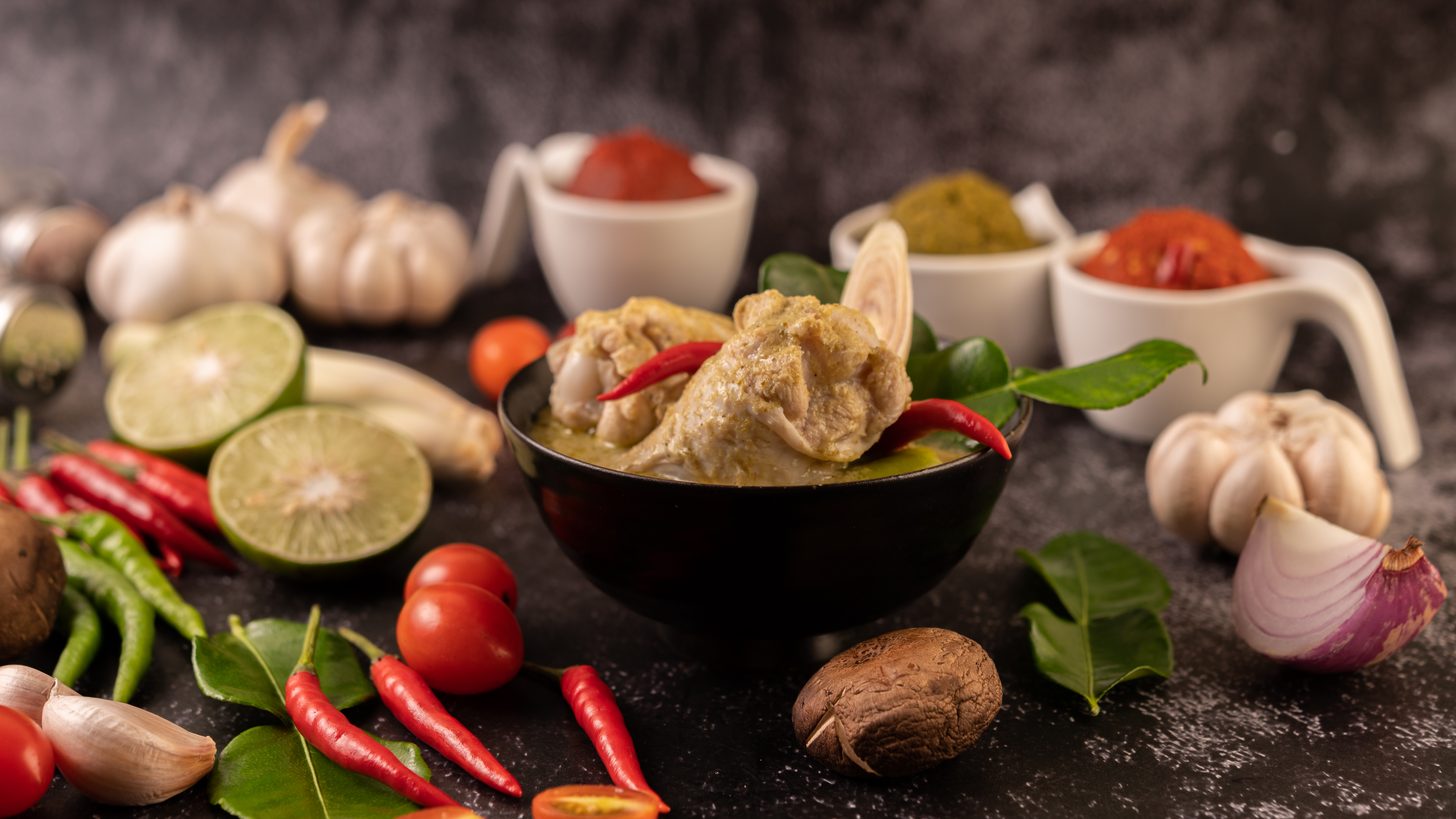 Fresh Thai curry ingredients — chilli, basil, lime and kaffir lime leaves