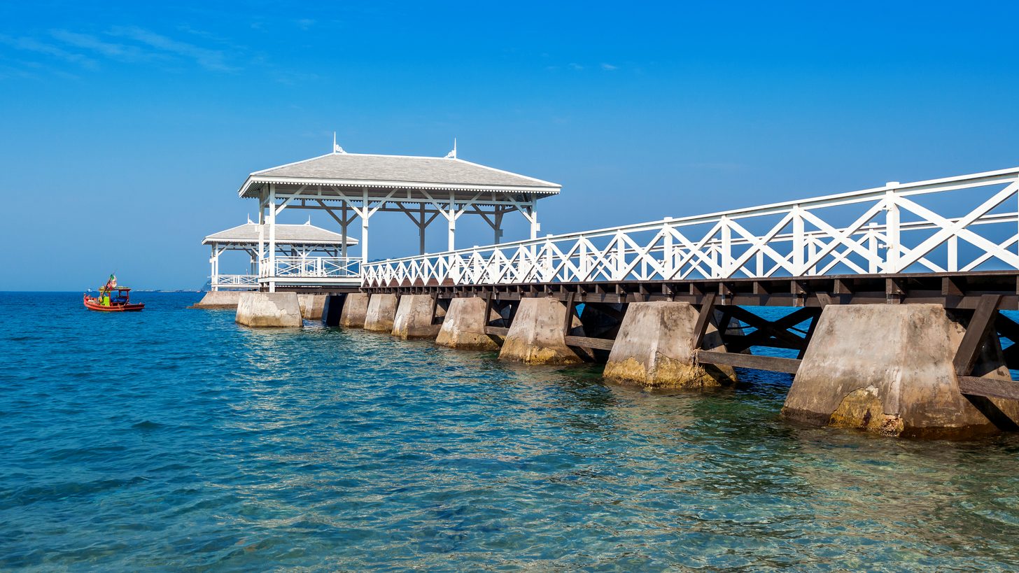 The white AsDang Bridge pavilion reaching into the sea at Koh Si Chang, the island off Si Racha near the Laem Chabang berths