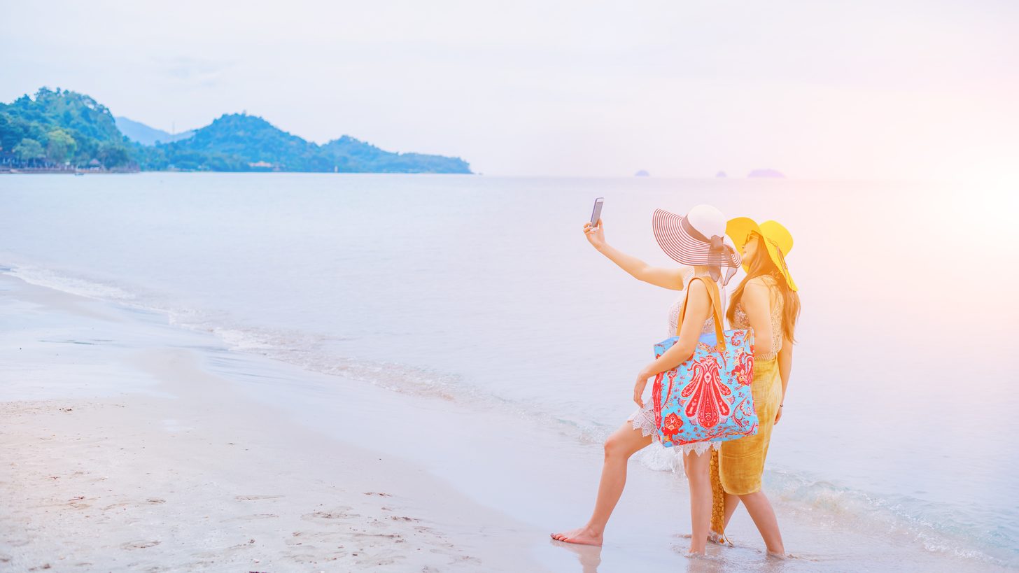 A same-sex couple enjoying a beach on a Thai island