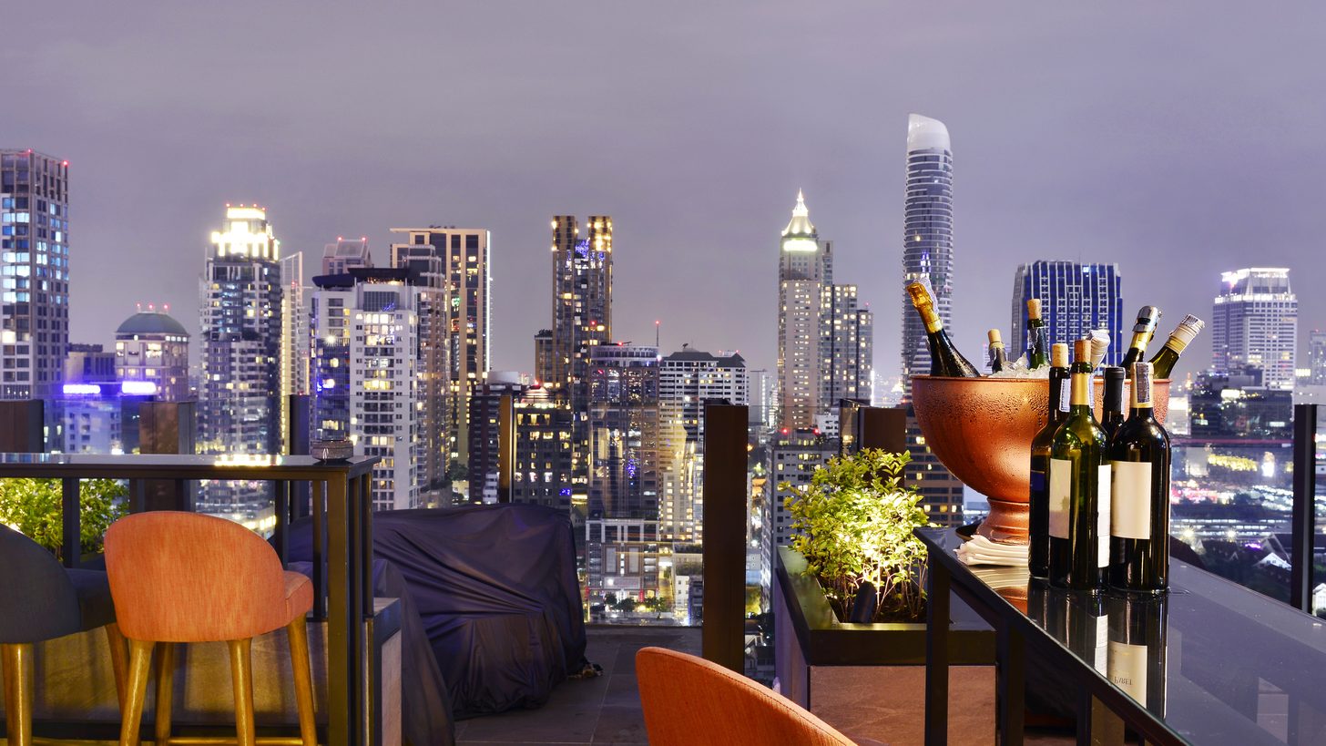 Bangkok's skyline at night seen from a rooftop bar