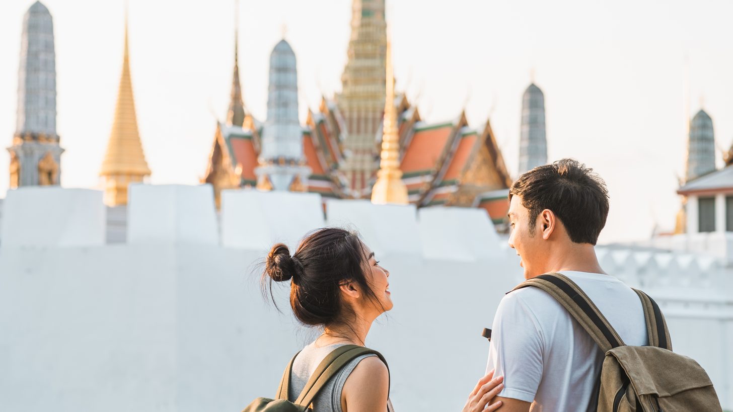 A travelling couple walking through Bangkok