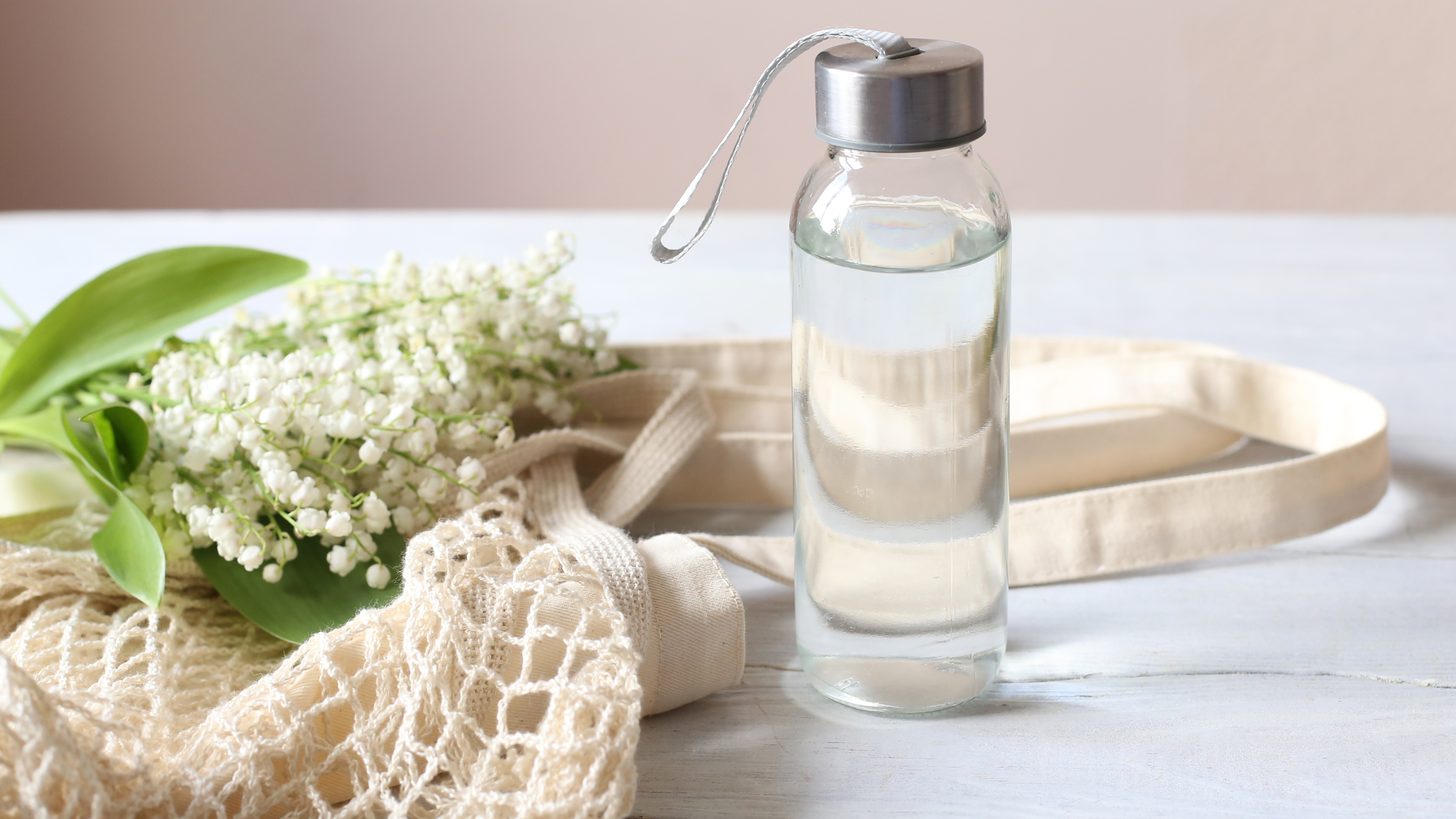 Reusable glass water bottles and bamboo amenities in a sustainable Thailand hotel room