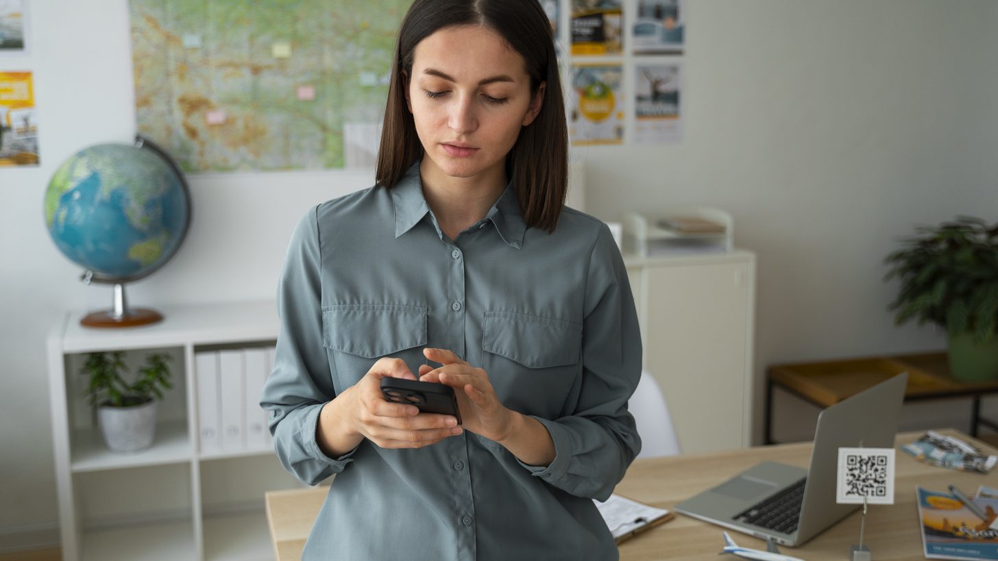 Travel agent reviewing a client's policy details on a phone before a Thailand trip