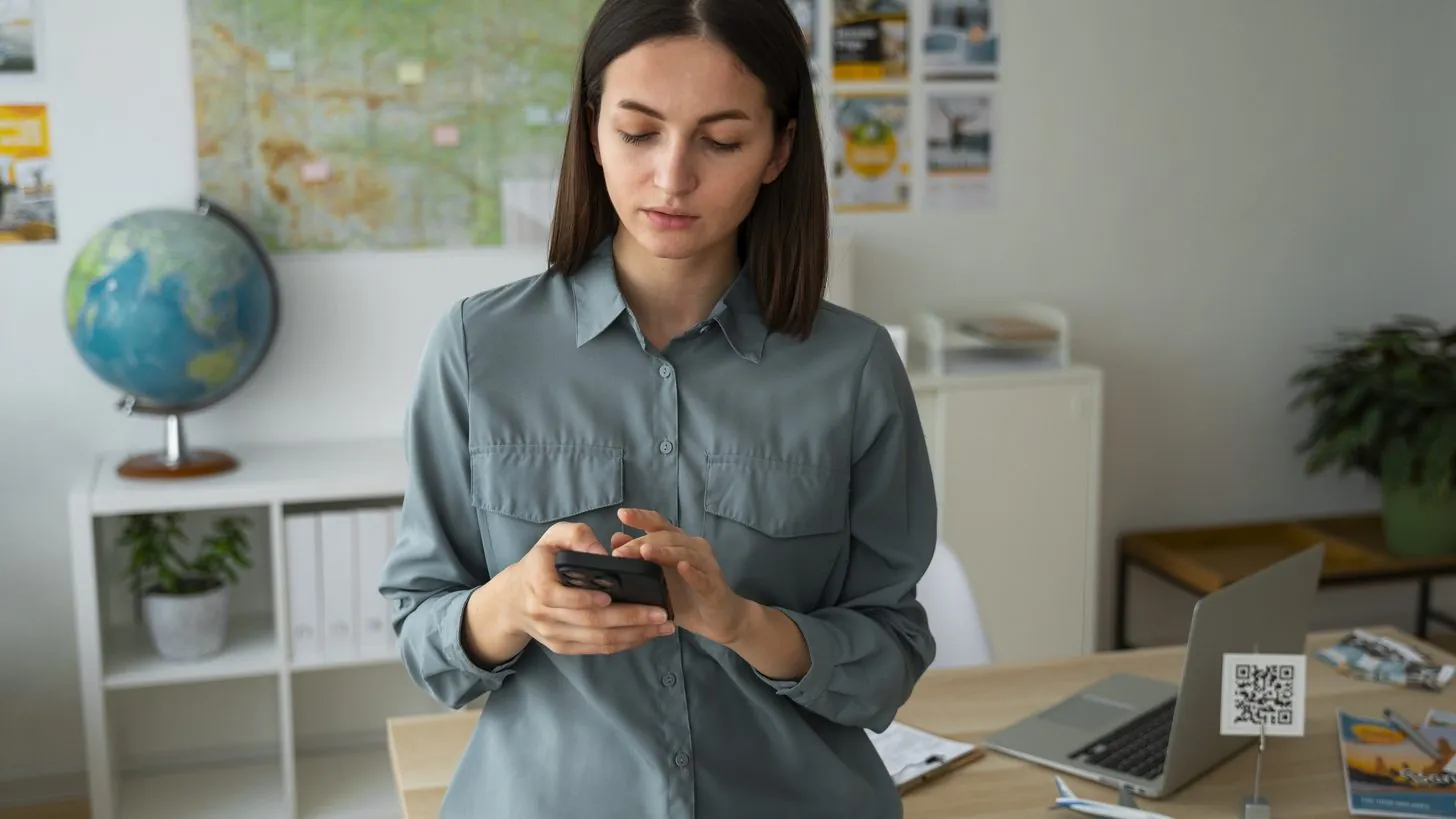 Travel agent reviewing a client's policy details on a phone before a Thailand trip