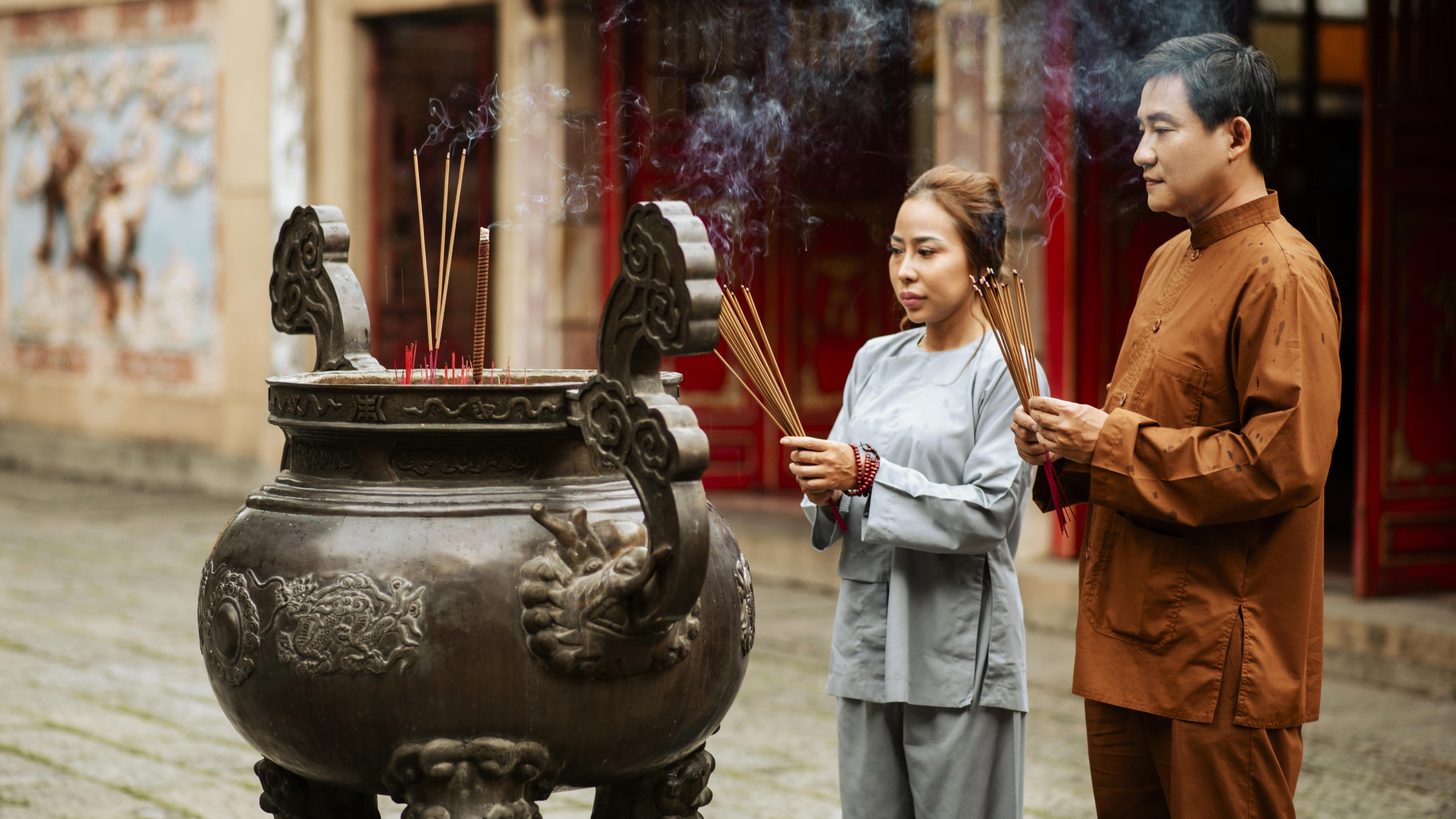 Traditional Chinese temple ceremony with incense and offerings in Thailand