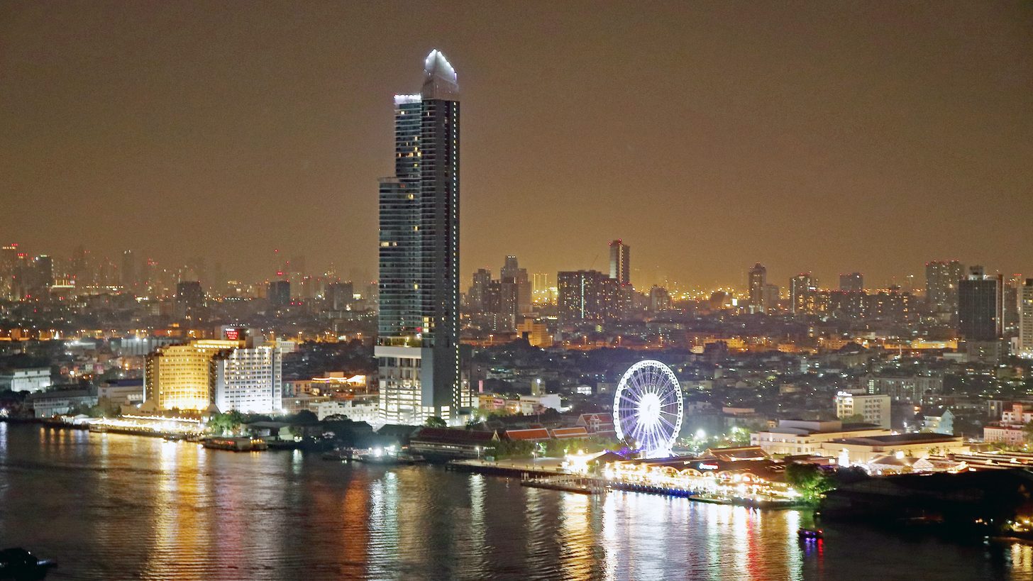 Asiatique The Riverfront night market and Ferris wheel lit up beside the Chao Phraya river