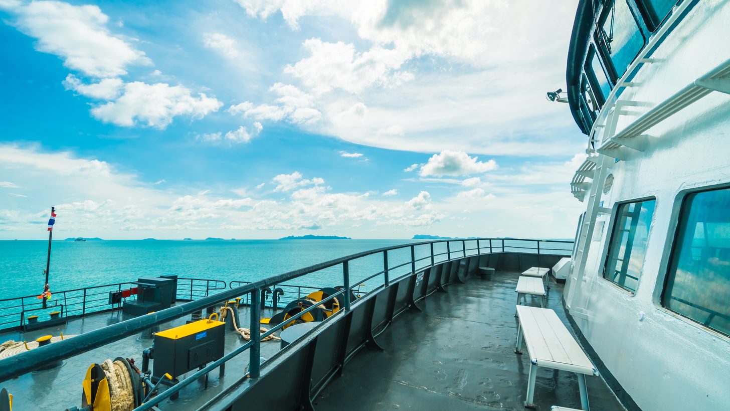Ferry crossing calm sea toward tropical gulf islands in southern Thailand