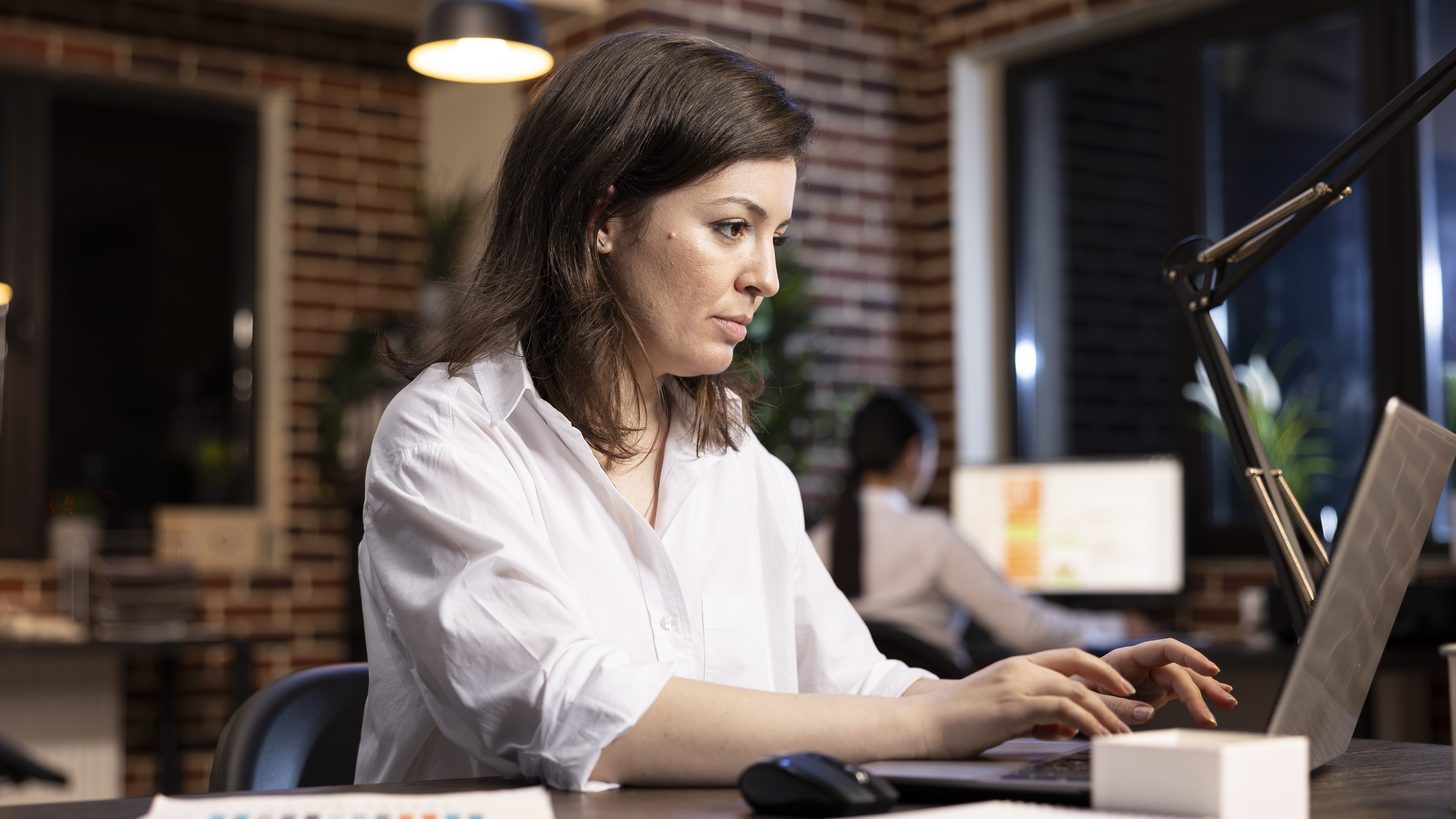 A travel professional working at a laptop