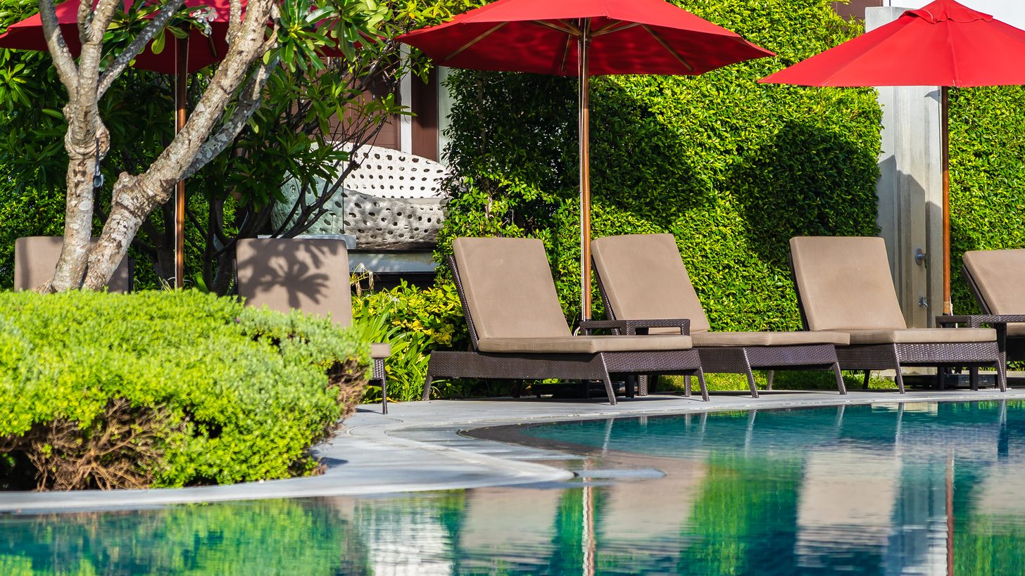 Sun loungers and umbrellas around a resort pool
