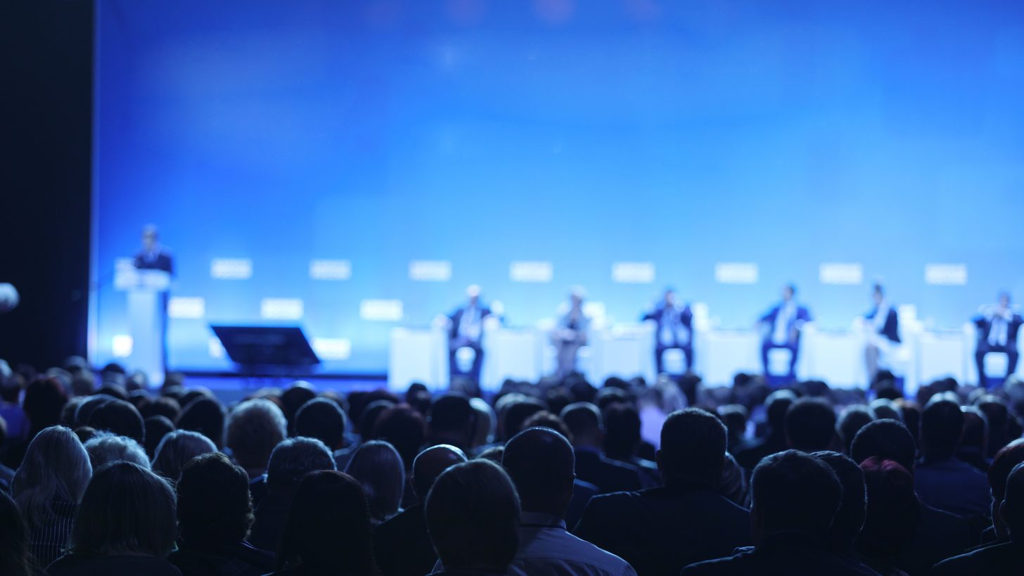 A conference audience in a modern event hall