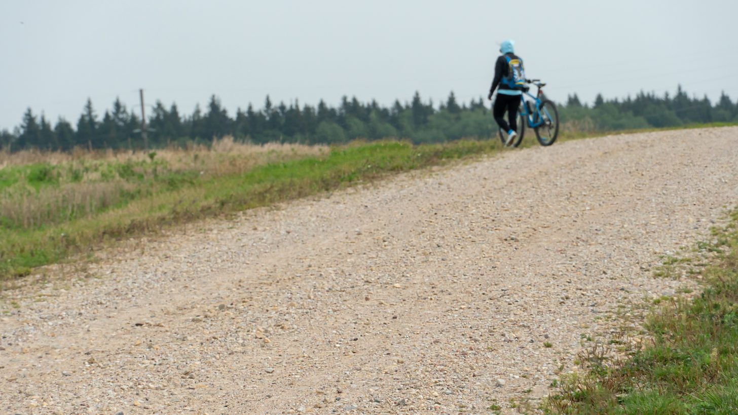 Gravel cyclists riding on a countryside dirt road
