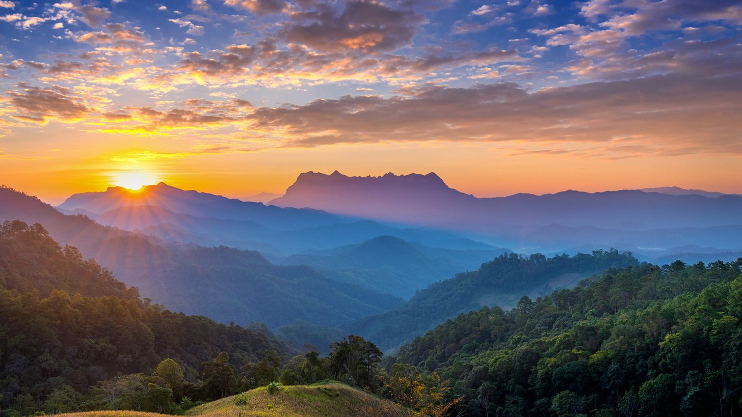 Morning light over misty mountain ridges in northern Thailand