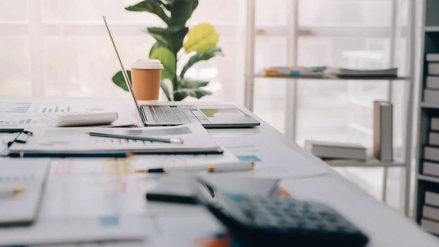 An advisor walking two clients through a written plan at an office table