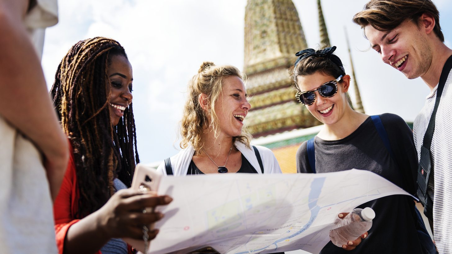 A guide with a group of travellers at a temple in Bangkok