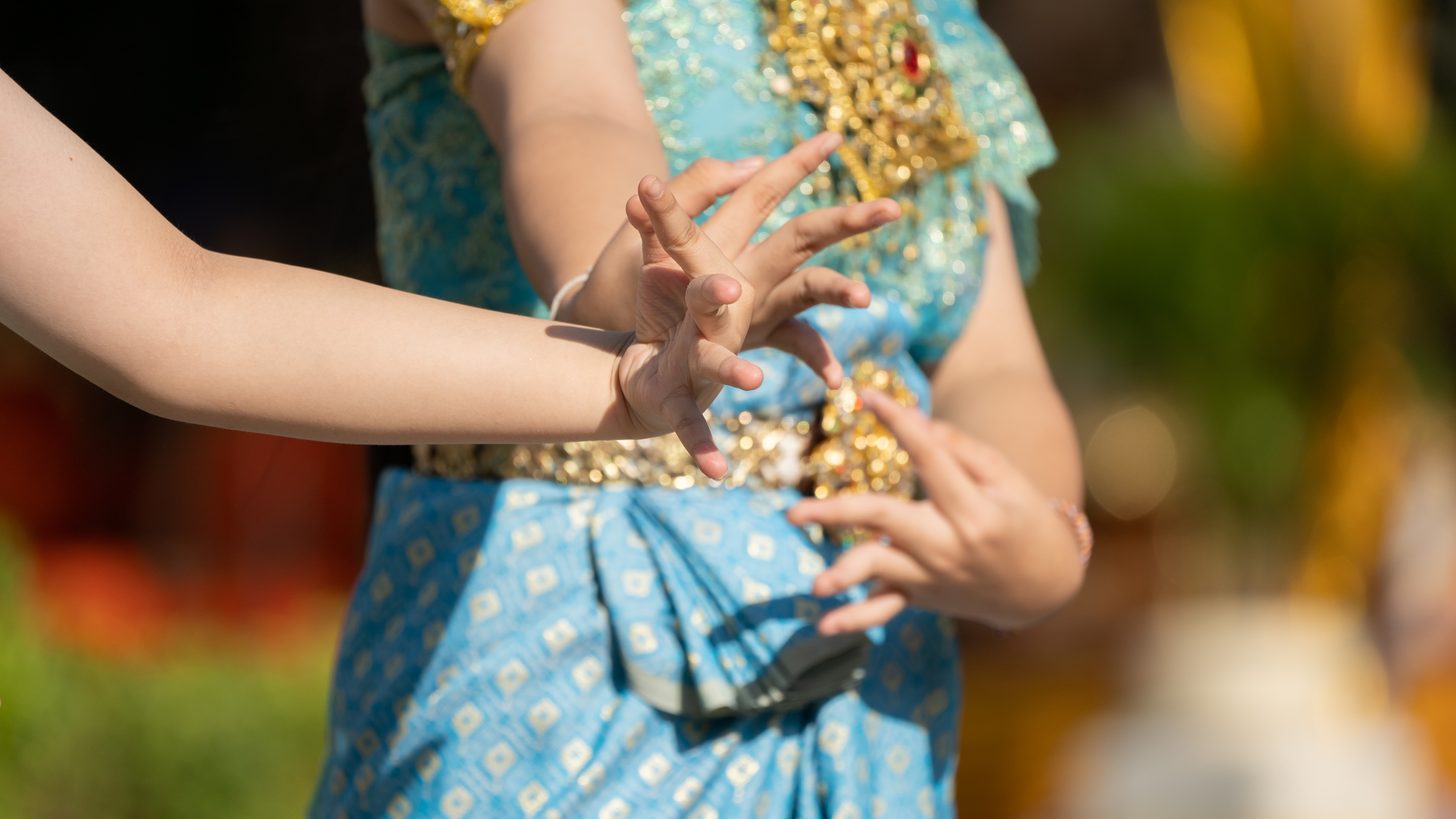 Thai traditional dancers performing in ornate costume