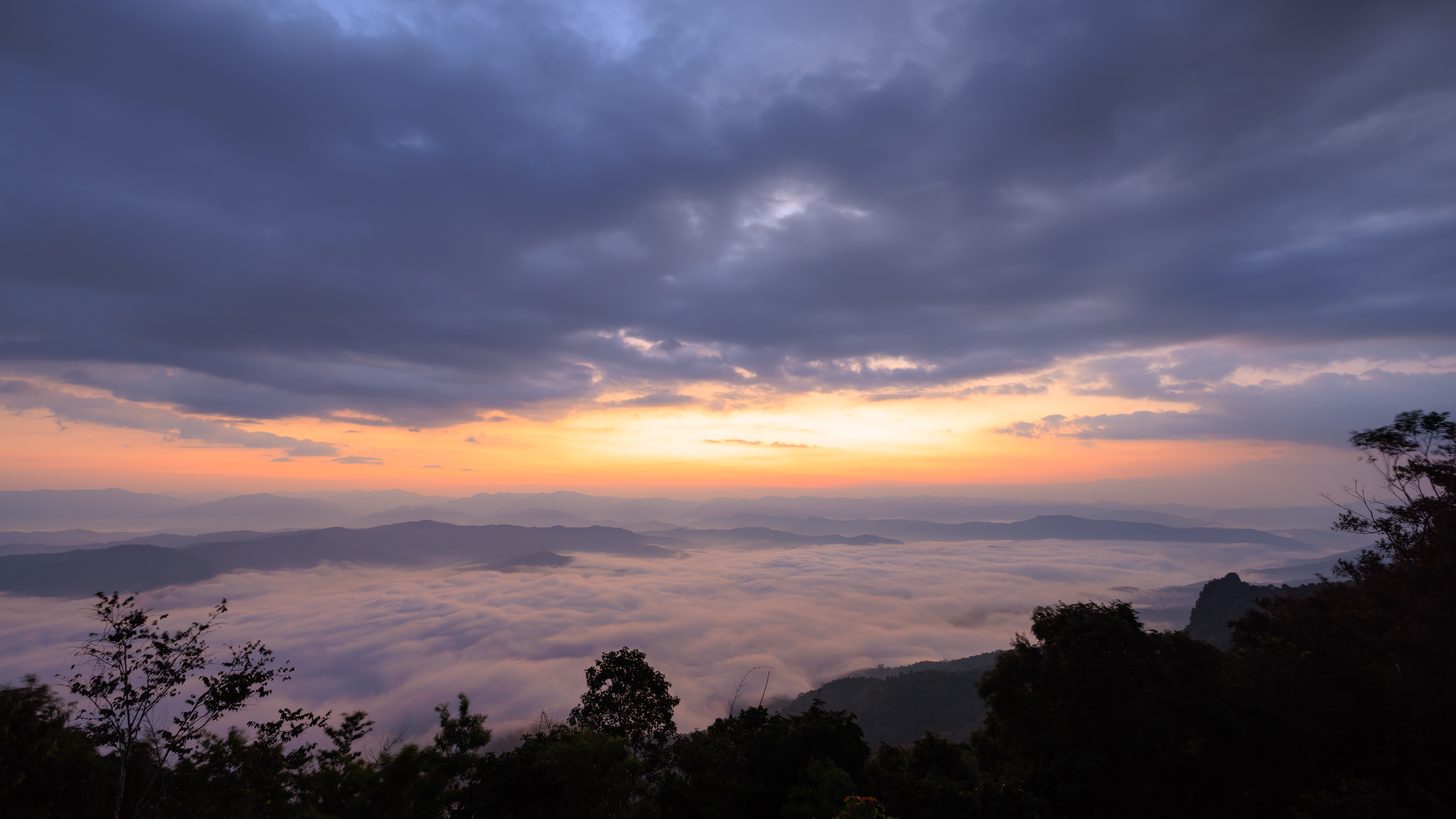 Misty mountain valley in northern Thailand at sunrise in the cool season