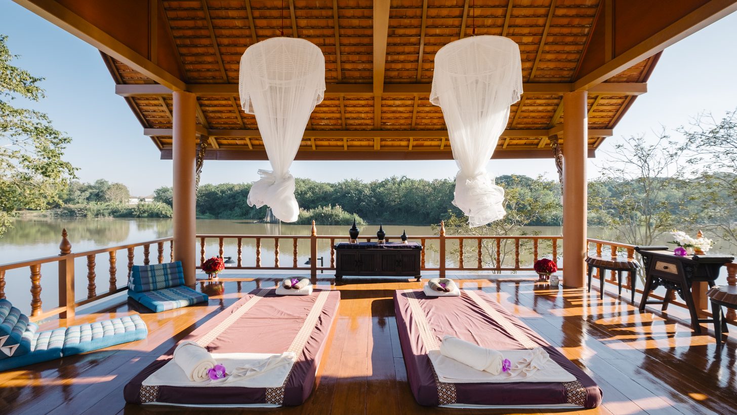 A spa treatment sala overlooking a resort garden pool in Thailand