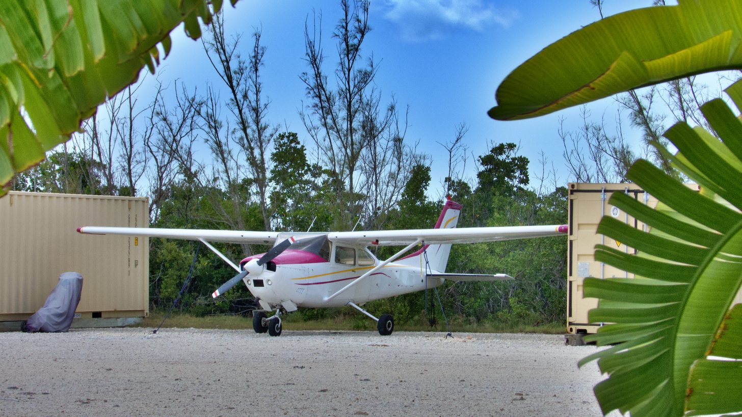 A regional turboprop aircraft parked on the apron at a small airport