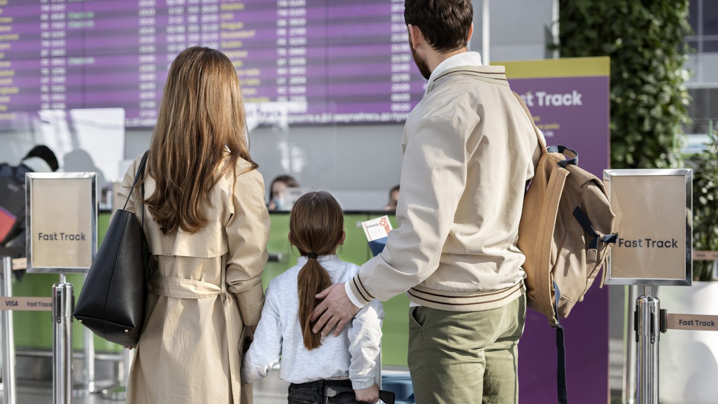 A family with luggage in an airport departure hall