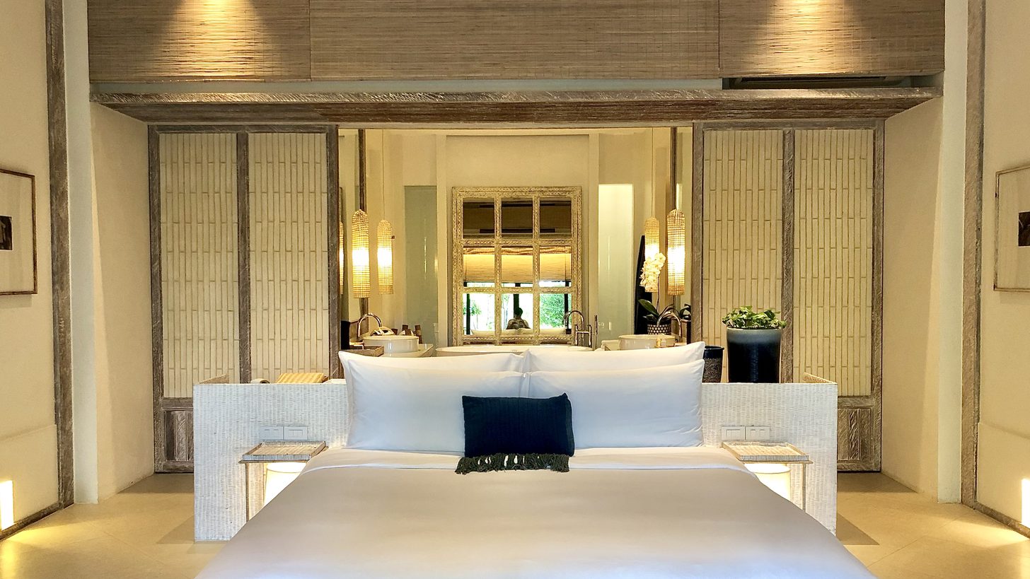 A well-appointed hotel room with a view over a terrace