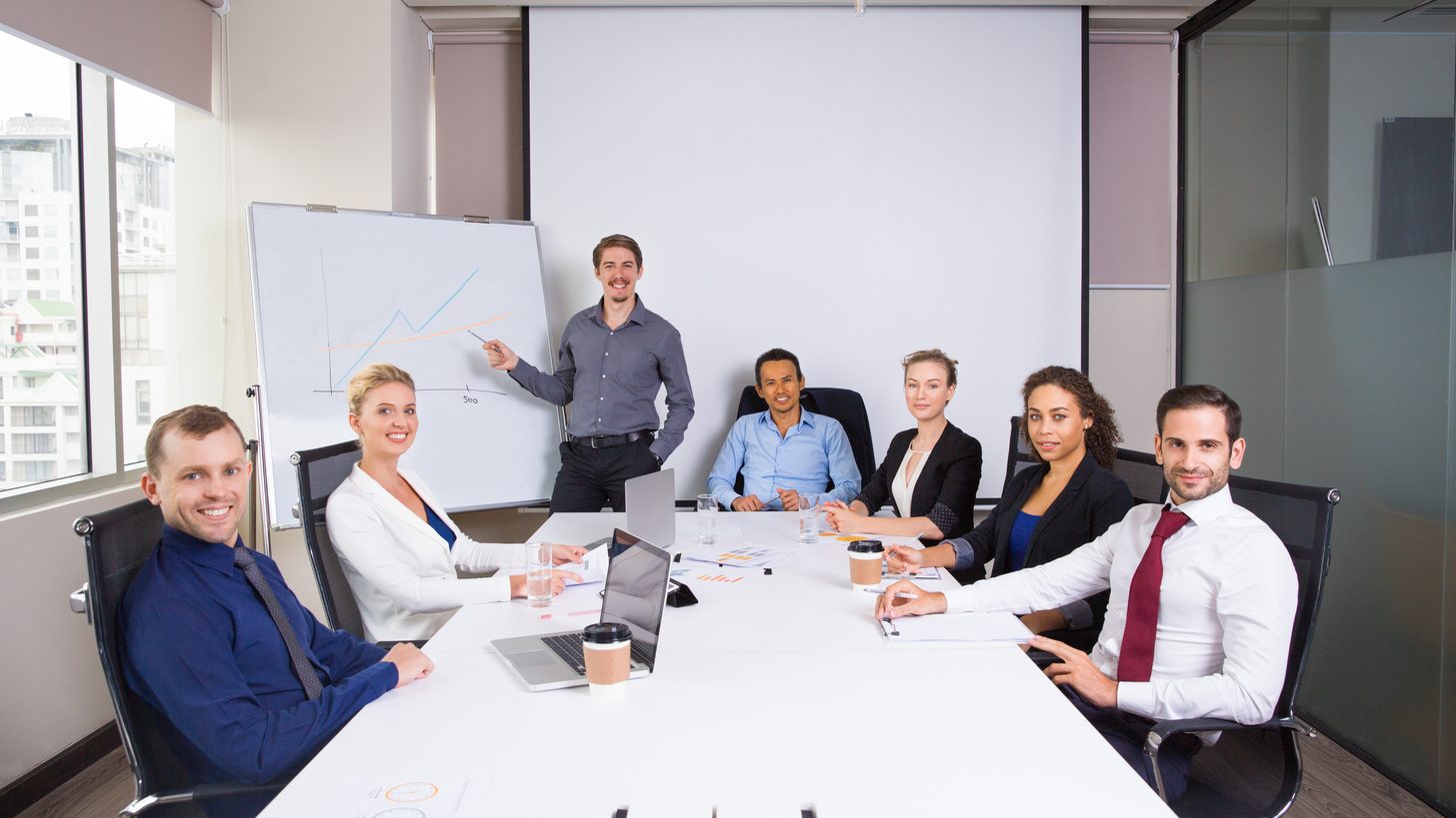 Colleagues gathered around a table in a meeting room