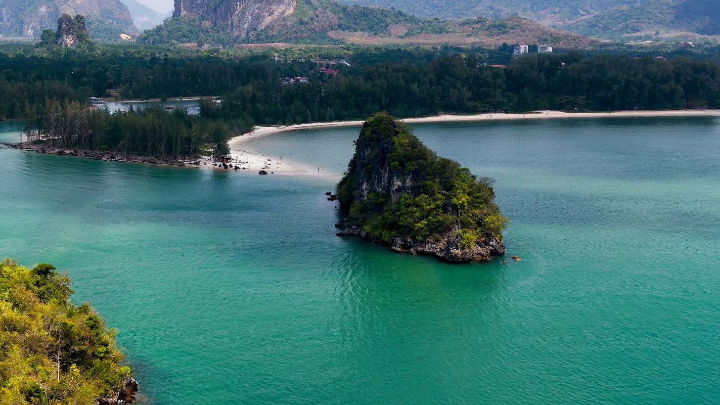 Limestone karst islands and turquoise water on the Krabi coastline at dawn