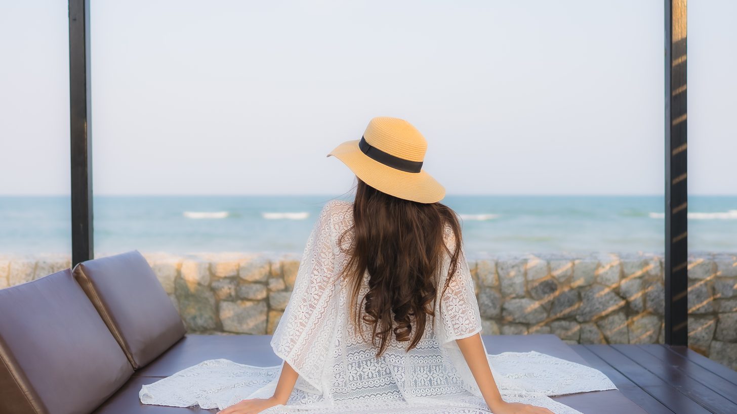 A solo traveller relaxing by the sea in Thailand