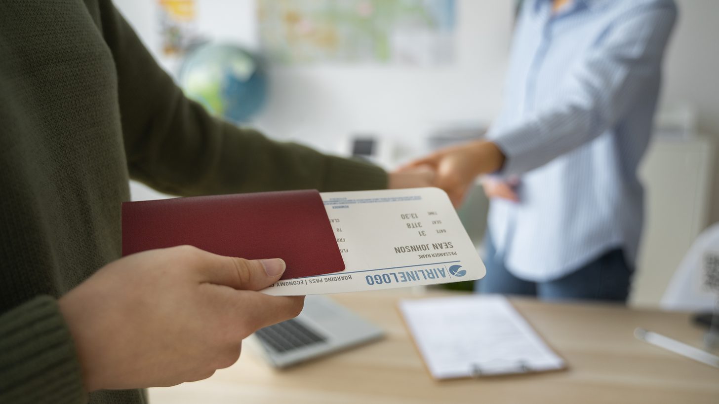 A travel consultant working at a desk on a group booking