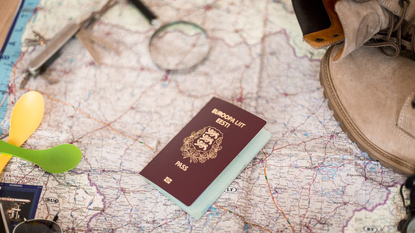 A passport and travel documents laid out on a map