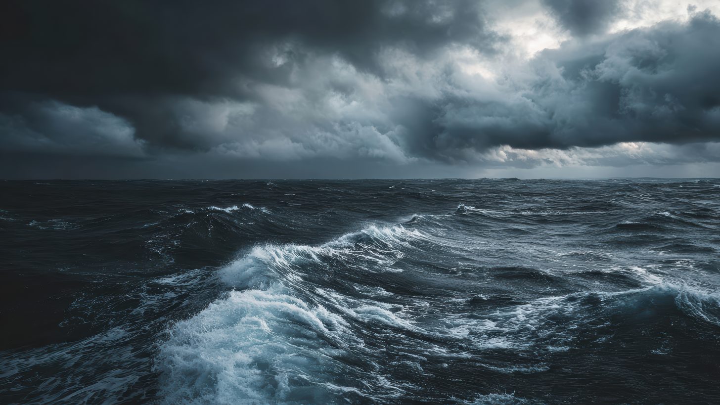 Rough sea with breaking waves seen from a boat under an overcast sky