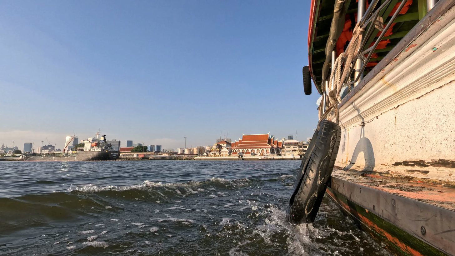 The view from a moving boat on a busy urban river