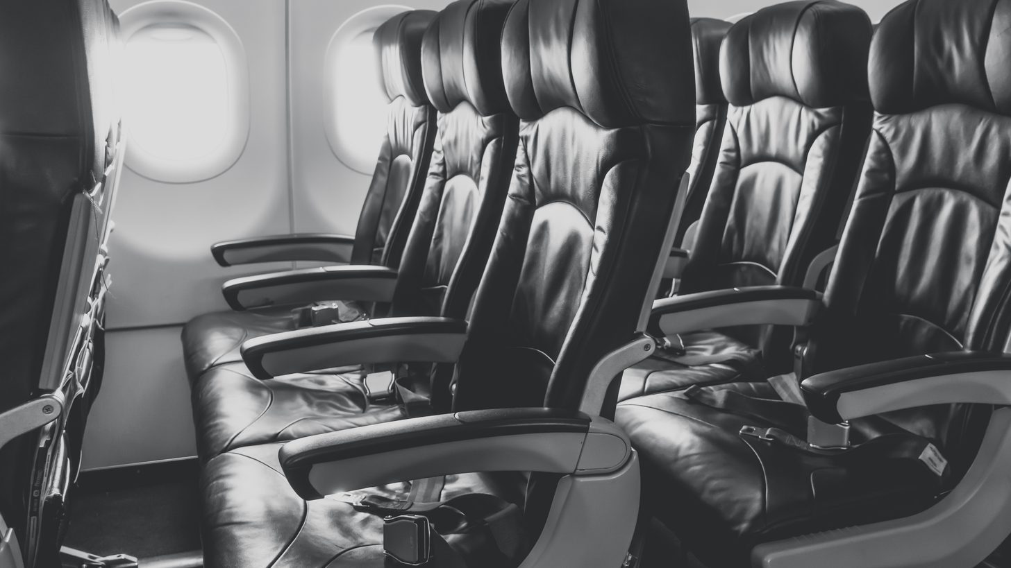 Rows of seats along an aircraft cabin aisle