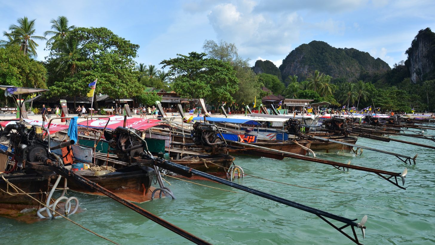 A traditional Thai longtail boat at the water's edge