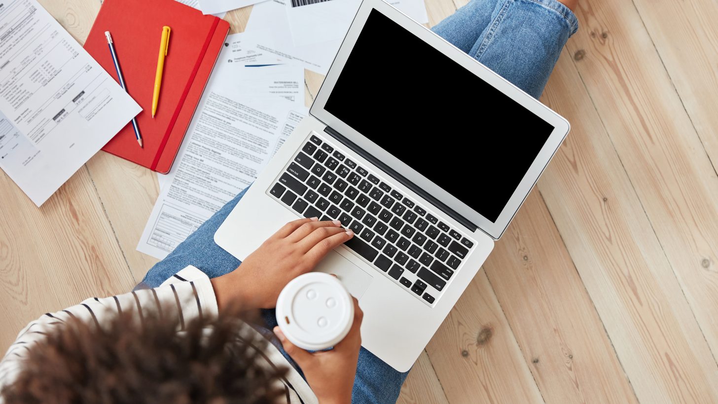 A person working on a laptop at home