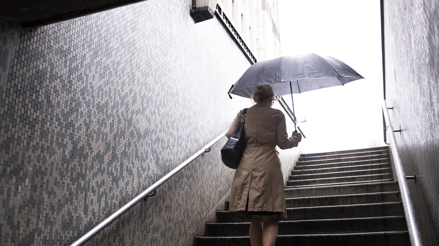 Rain falling heavily on a wet city street