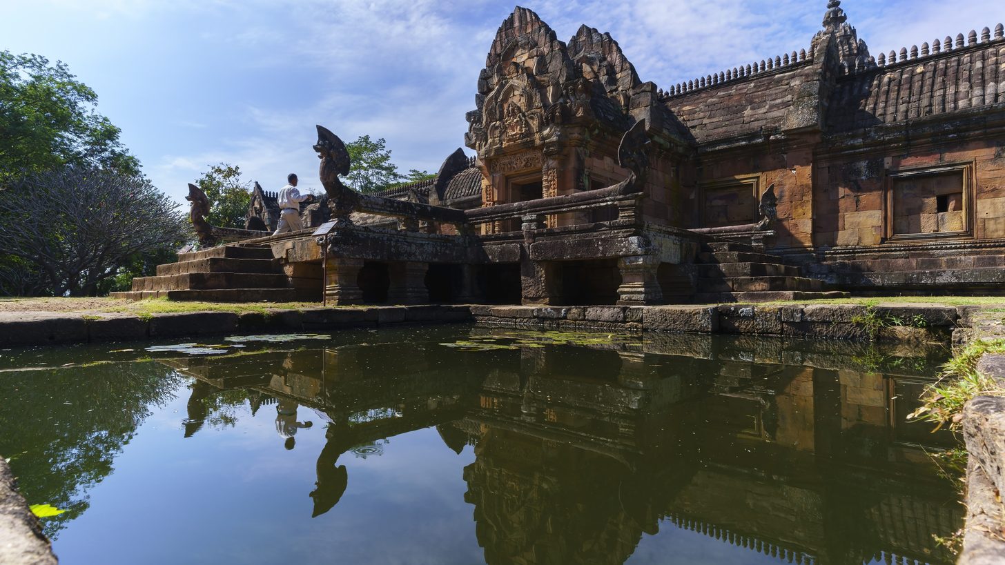 The sandstone Khmer sanctuary of Prasat Hin Phanom Rung in Buriram, reflected in its stone-lined pond