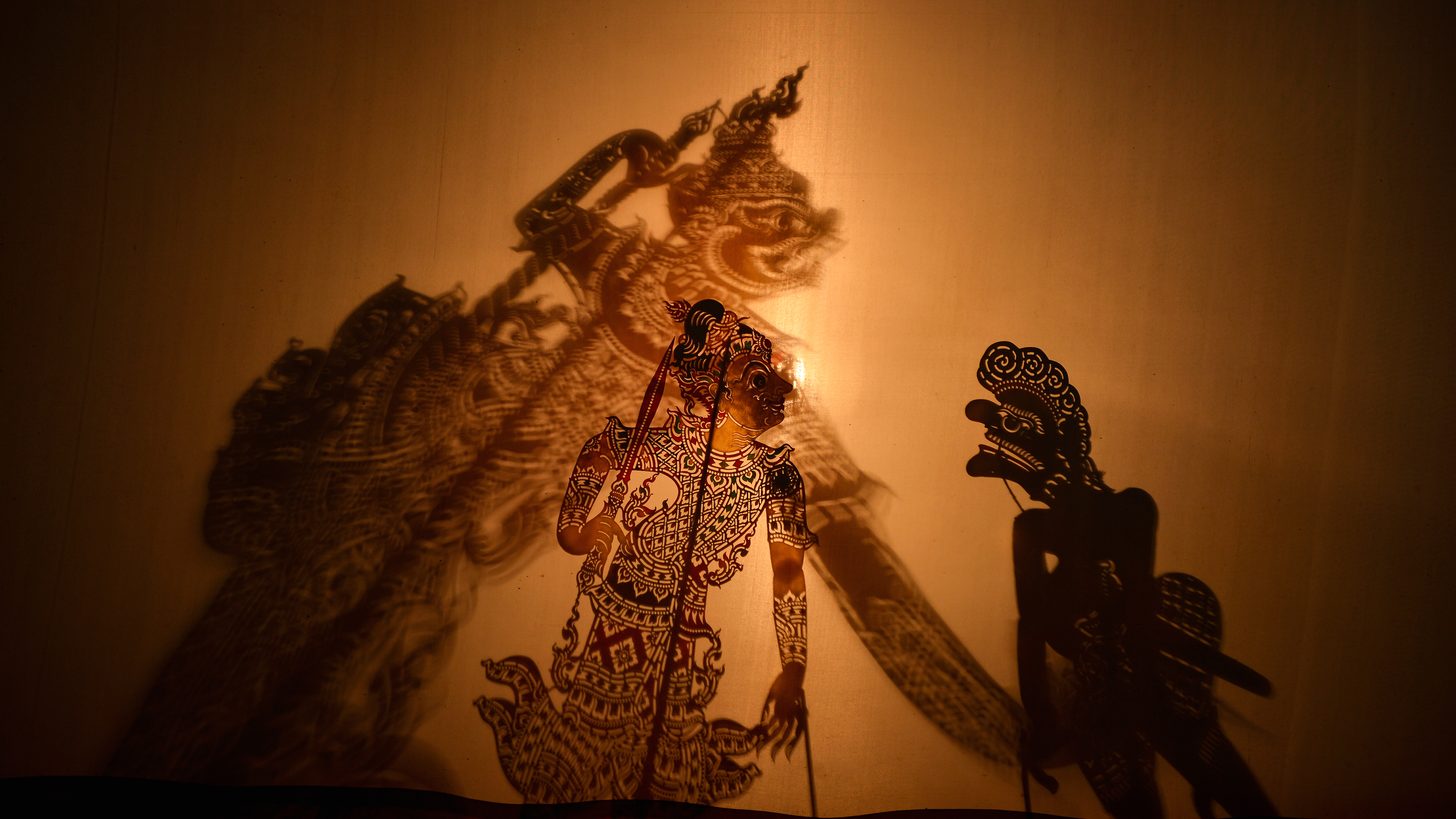 A southern Thai shadow puppet performance lit from behind a screen