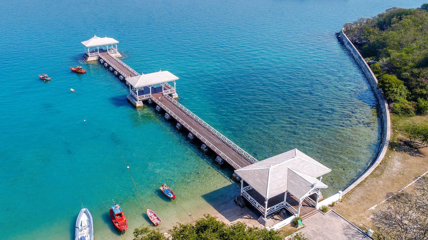 A wooden waterfront pavilion and walkway on a Gulf of Thailand island