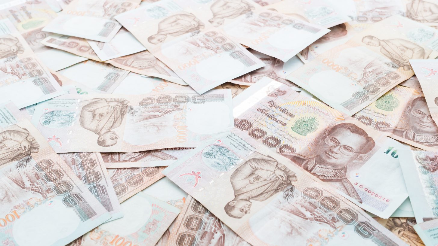Thai one-thousand-baht banknotes spread across a surface