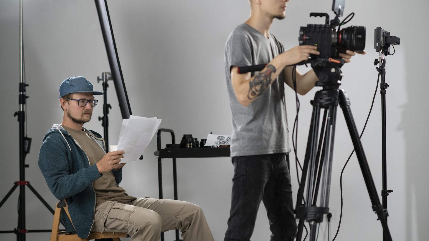 A film crew working together around a camera on location