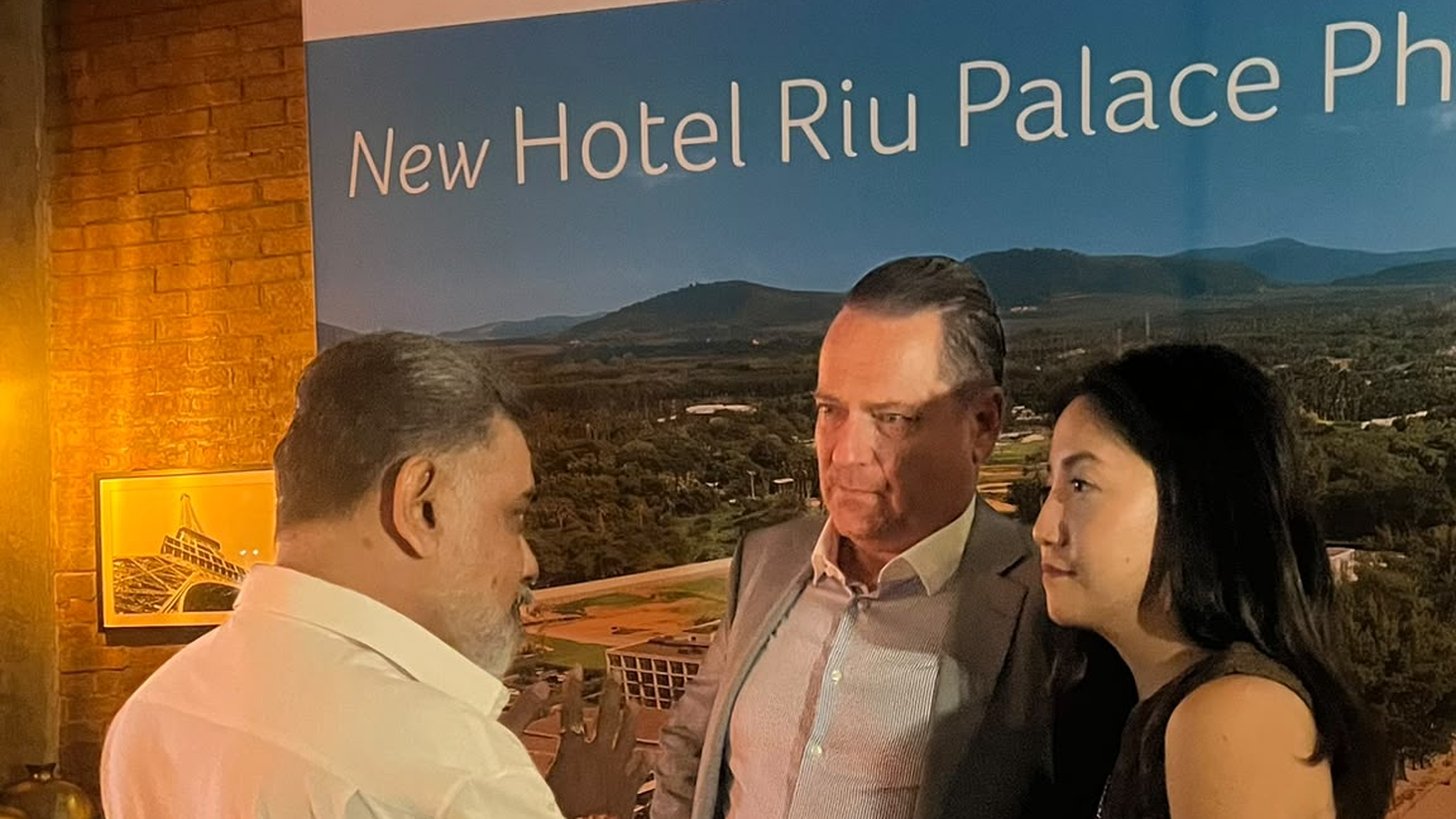 Our Director in conversation with the RIU team in front of the Riu Palace Phuket display