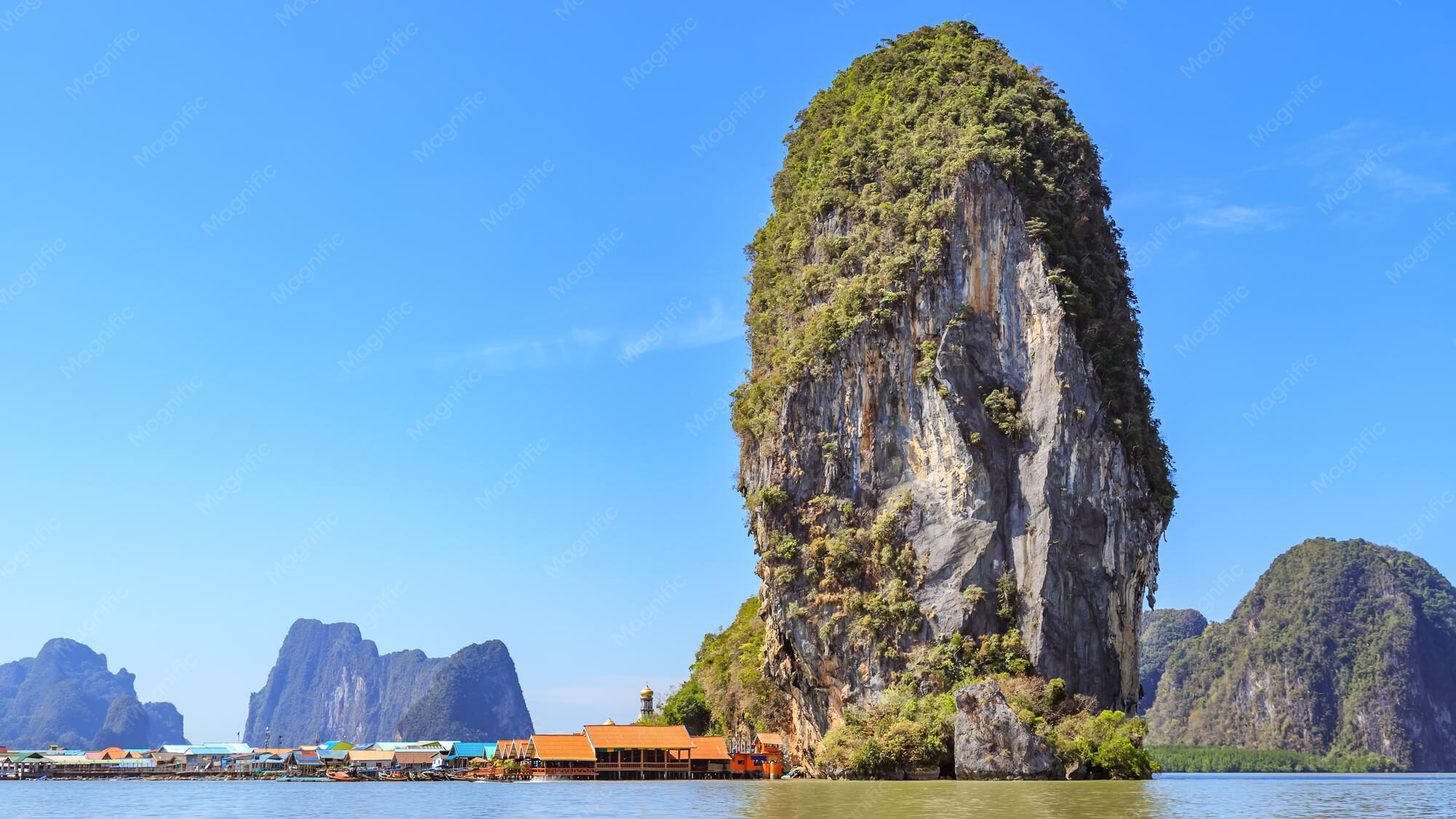 Ko Panyi stilt village beneath a limestone rock in Phang Nga Bay near Phuket, Thailand