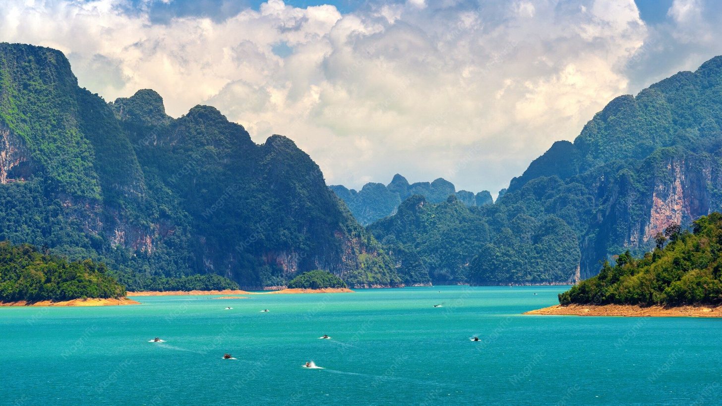 Limestone mountains rising above the turquoise water of Ratchaprapha Dam in Khao Sok National Park, Surat Thani, Thailand
