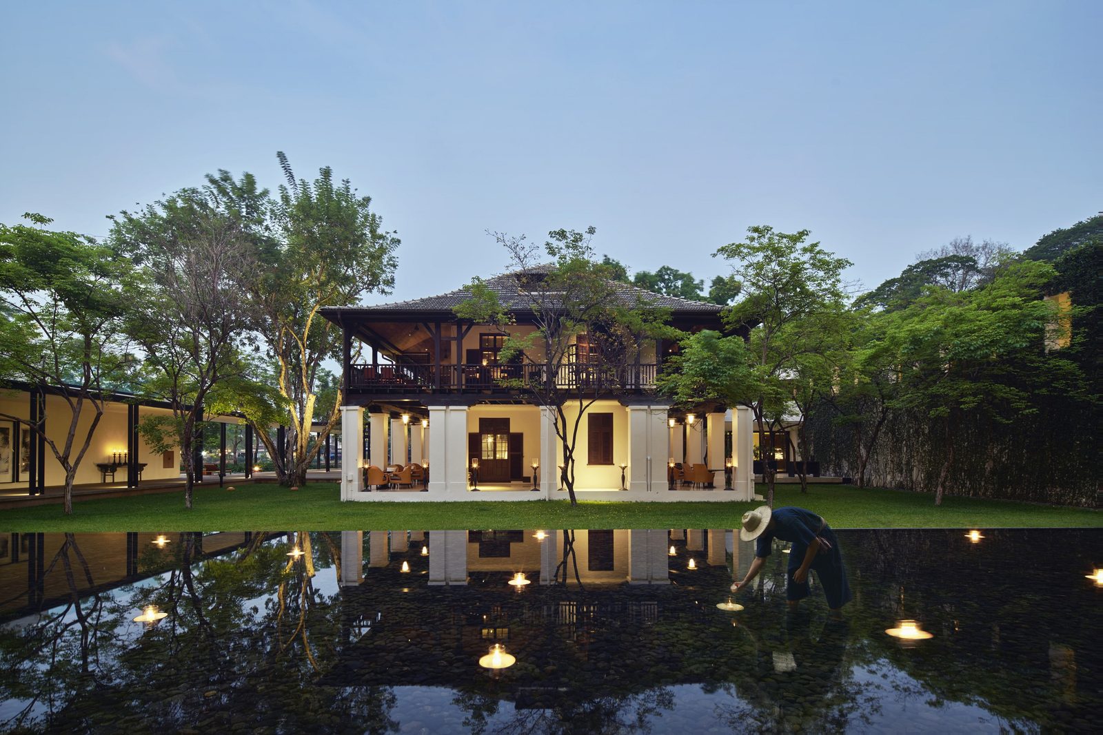 The heritage 1921 House reflected in a pond at dusk, Anantara Chiang Mai Resort