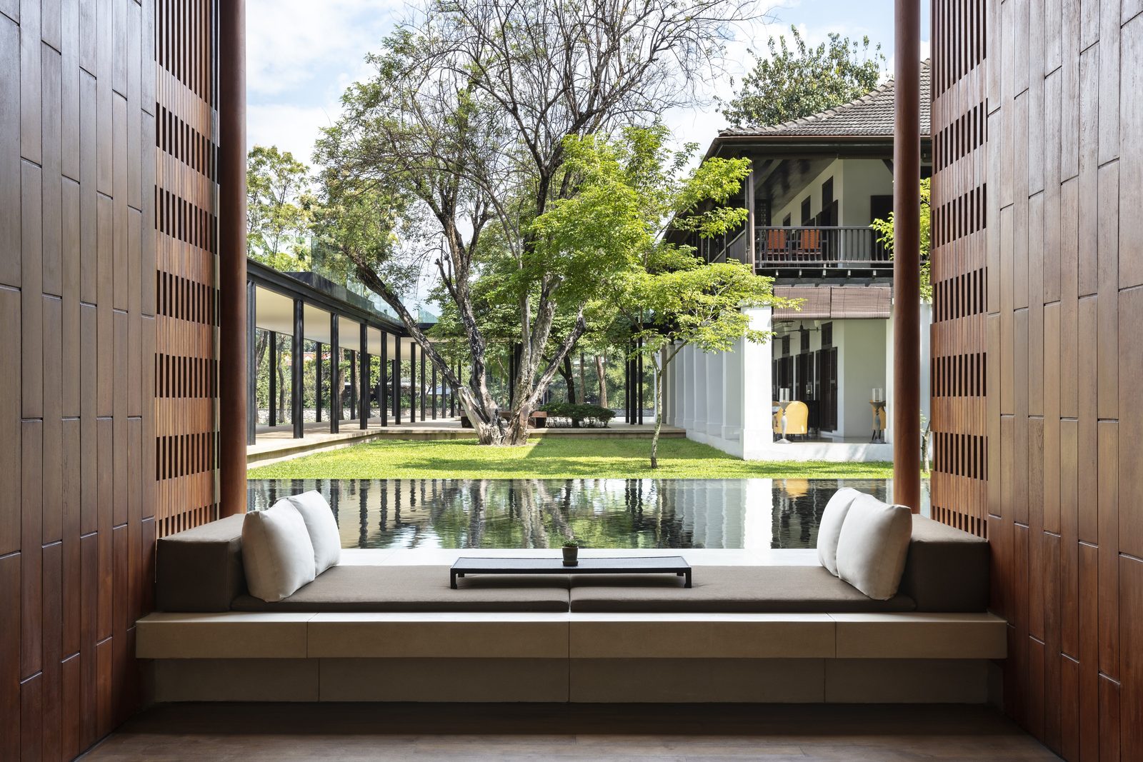 Lobby seating looking over a reflecting pool to the gardens at Anantara Chiang Mai Resort