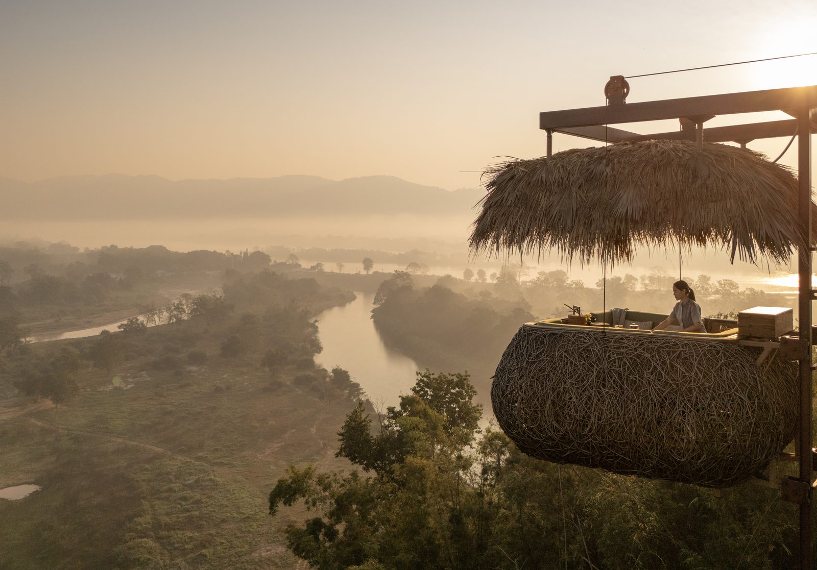 Canopy treetop dining capsule at breakfast above the valley at Anantara Golden Triangle