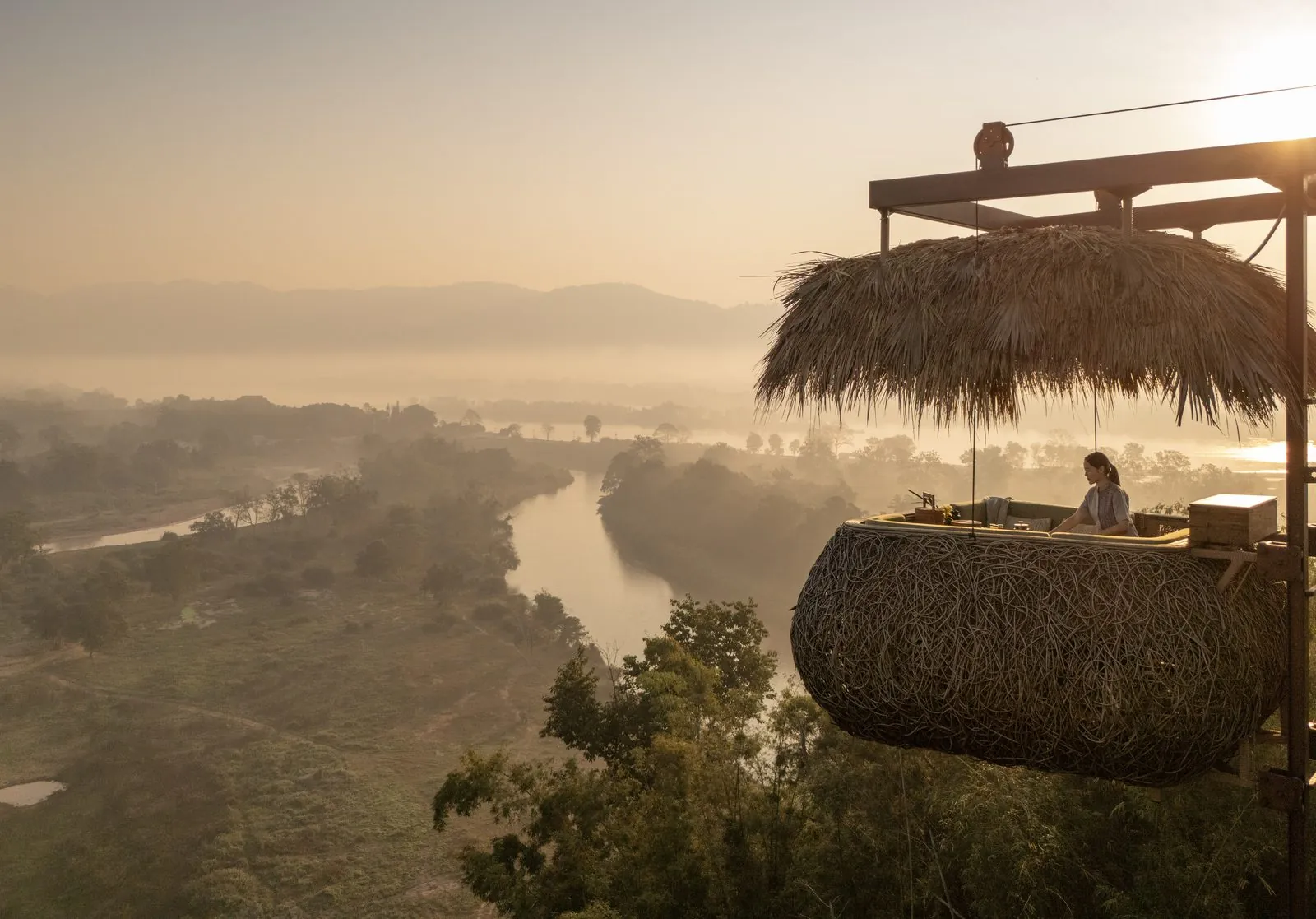 Canopy treetop dining capsule at breakfast above the valley at Anantara Golden Triangle