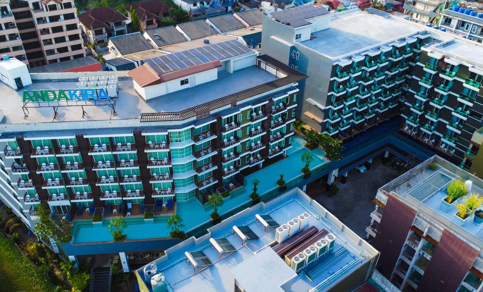 Aerial view of Andakira Hotel Patong's buildings and rooftop pool in central Patong, Phuket