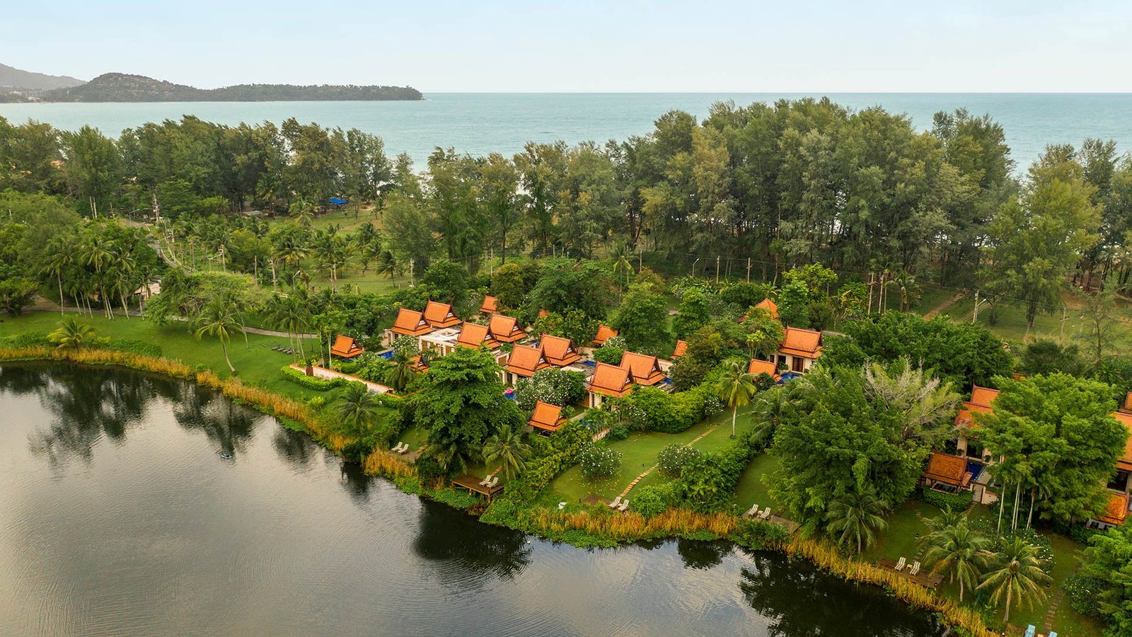 Aerial view of pool villas on the lagoon at Banyan Tree Phuket, with the Andaman Sea beyond